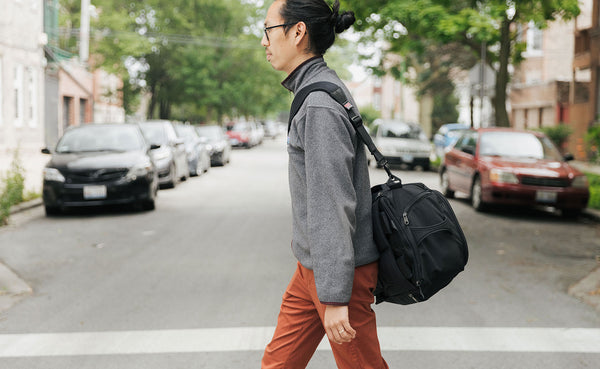 A person walking and wearing the Techonaut 30 with a shoulder strap.